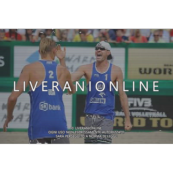 24.08.2014 - Stare Jablonki , siatkowka plazowa , beach volleyball , World Tour , FIVB Stare Jablonki Grand Slam 2014 , USA (niebieskie) - Austria (czarne) , USA (blue) - Austria (black) N/Z Jacob Gibb Fot. Karol Bartnik / MPAimages.com/NEWSPIX.PL --- Newspix.pl /Agenzia Aldo Liverani sas - ITALY ONLY - EDITORIAL USE ONLY - BEACHVOLLEY *** Local Caption *** www.newspix.pl mail us: info@newspix.pl call us: 0048 022 23 22 222 --- Polish Picture Agency by Ringier Axel Springer Poland