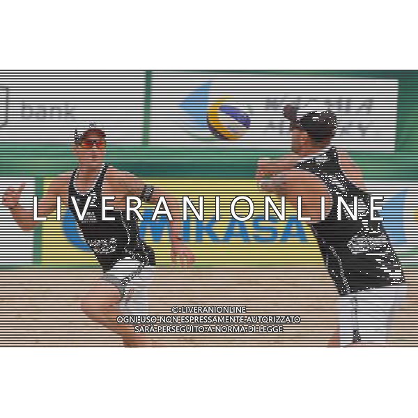 24.08.2014 - Stare Jablonki , siatkowka plazowa , beach volleyball , World Tour , FIVB Stare Jablonki Grand Slam 2014 , USA (granatowe) - Austria (czarne) , USA - Austria N/Z Alexander Horst , Clemens Doppler Fot. Mariusz Palczynski / MPAimages.com/NEWSPIX.PL --- Newspix.pl /Agenzia Aldo Liverani sas - ITALY ONLY - EDITORIAL USE ONLY - BEACHVOLLEY *** Local Caption *** www.newspix.pl mail us: info@newspix.pl call us: 0048 022 23 22 222 --- Polish Picture Agency by Ringier Axel Springer Poland