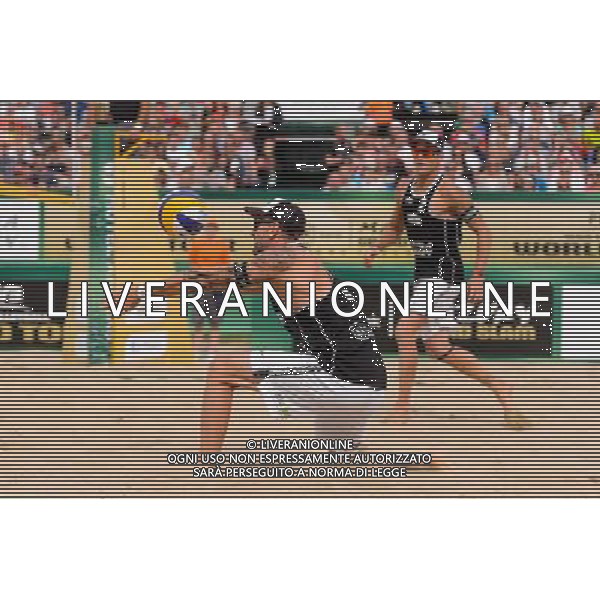 24.08.2014 - Stare Jablonki , siatkowka plazowa , beach volleyball , World Tour , FIVB Stare Jablonki Grand Slam 2014 , USA (granatowe) - Austria (czarne) , USA - Austria N/Z Clemens Doppler Fot. Mariusz Palczynski / MPAimages.com/NEWSPIX.PL --- Newspix.pl /Agenzia Aldo Liverani sas - ITALY ONLY - EDITORIAL USE ONLY - BEACHVOLLEY *** Local Caption *** www.newspix.pl mail us: info@newspix.pl call us: 0048 022 23 22 222 --- Polish Picture Agency by Ringier Axel Springer Poland