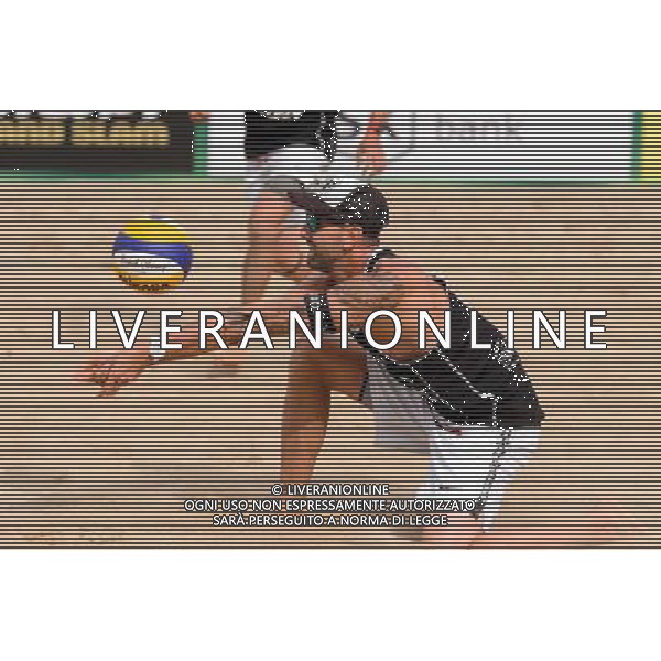 24.08.2014 - Stare Jablonki , siatkowka plazowa , beach volleyball , World Tour , FIVB Stare Jablonki Grand Slam 2014 , USA (granatowe) - Austria (czarne) , USA - Austria N/Z Clemens Doppler Fot. Mariusz Palczynski / MPAimages.com/NEWSPIX.PL --- Newspix.pl /Agenzia Aldo Liverani sas - ITALY ONLY - EDITORIAL USE ONLY - BEACHVOLLEY *** Local Caption *** www.newspix.pl mail us: info@newspix.pl call us: 0048 022 23 22 222 --- Polish Picture Agency by Ringier Axel Springer Poland