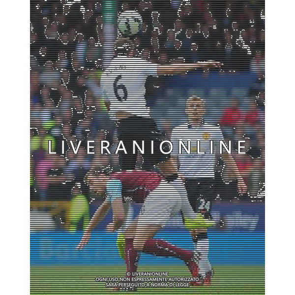 Manchester United\'s Jonny Evans heads clear under pressure from Burnley\'s Ashley Barnes Photographer Chris Vaughan/CameraSport Football - Barclays Premiership - Burnley v Manchester United - Saturday 30th August 2014 - Turf Moor - Burnley © CameraSport - 43 Linden Ave. Countesthorpe. Leicester. England. LE8 5PG - Tel: +44 (0) 116 277 4147 - admin@camerasport.com - www.camerasport.com /Agenzia Aldo Liverani sas - ITALY ONLY - EDITORIAL USE ONLY