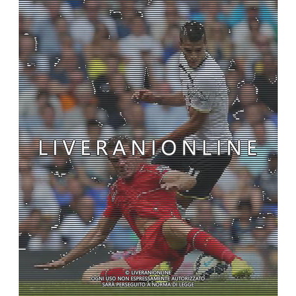 Liverpool\'s Jordan Henderson despite the attentions of Tottenham Hotspur\'s Erik Lamela Photographer Kieran Galvin/CameraSport Football - Barclays Premiership - Tottenham Hotspur v Liverpool - Sunday 31st August 2014 - White Hart Lane - London Â© CameraSport - 43 Linden Ave. Countesthorpe. Leicester. England. LE8 5PG - Tel: +44 (0) 116 277 4147 - admin@camerasport.com - www.camerasport.com /Agenzia Aldo Liverani sas - ITALY ONLY - EDITORIAL USE ONLY