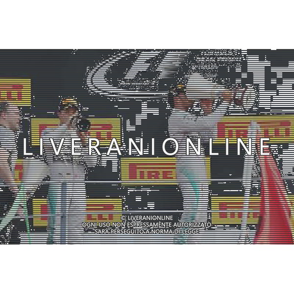 Race winner Lewis Hamilton (GBR) Mercedes AMG F1 (Right) celebrates on the podium with team mate Lewis Hamilton (GBR) Mercedes AMG F1 (Left). 07.09.2014. Formula 1 World Championship, Rd 13, Italian Grand Prix, Monza, Italy, Race Day. - www.xpbimages.com, EMail: requests@xpbimages.com - copy of publication required for printed pictures. Every used picture is fee-liable. © Copyright: Moy / XPB Images /AGENZIA ALDO LIVERANI SAS - ITALY ONLY - Gp F1 Monza italia Gara