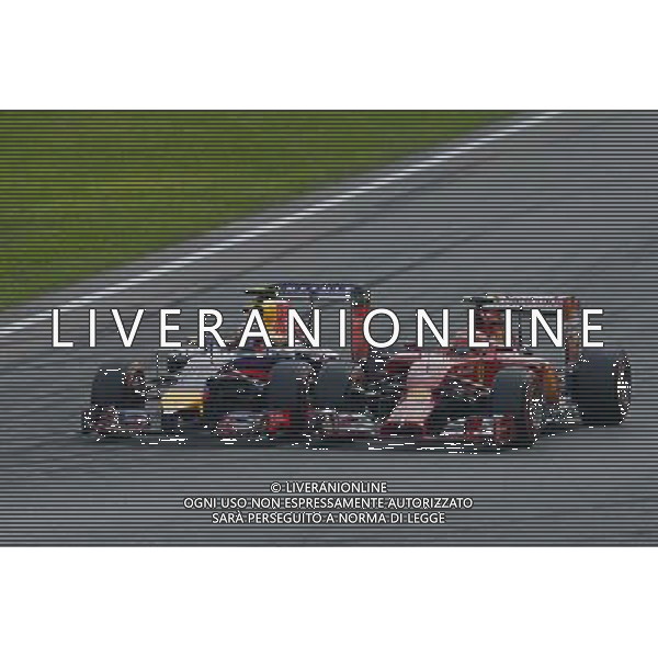 Daniel Ricciardo (AUS) Red Bull Racing RB10 and Kimi Raikkonen (FIN) Ferrari F14-T battle for position. 07.09.2014. Formula 1 World Championship, Rd 13, Italian Grand Prix, Monza, Italy, Race Day. AG ALDO LIVERANI SAS ONLY ITALY