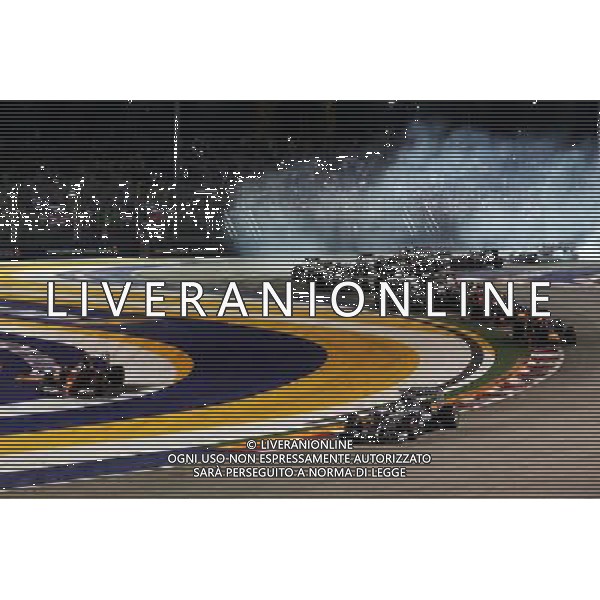 Lewis Hamilton (GBR) Mercedes AMG F1 W05 leads at the start of the race as Fernando Alonso (ESP) Ferrari F14-T runs wide. 21.09.2014. Formula 1 World Championship, Rd 14, Singapore Grand Prix, Singapore, Singapore, Race Day. AG ALDO LIVERANI SAS ONLY ITALY