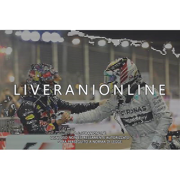 (L to R): Second placed Sebastian Vettel (GER) Red Bull Racing celebrates with race winner Lewis Hamilton (GBR) Mercedes AMG F1 in parc ferme. 21.09.2014. Formula 1 World Championship, Rd 14, Singapore Grand Prix, Singapore, Singapore, Race Day. AG ALDO LIVERANI SAS ONLY ITALY