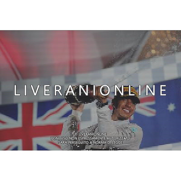 Race winner Lewis Hamilton (GBR) Mercedes AMG F1 celebrates on the podium. 21.09.2014. Formula 1 World Championship, Rd 14, Singapore Grand Prix, Singapore, Singapore, Race Day. 