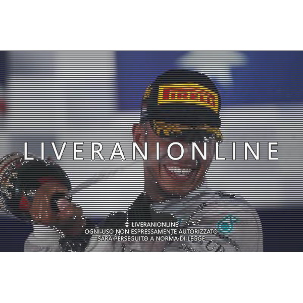 Race winner Lewis Hamilton (GBR) Mercedes AMG F1 celebrates on the podium. 21.09.2014. Formula 1 World Championship, Rd 14, Singapore Grand Prix, Singapore, Singapore, Race Day. 