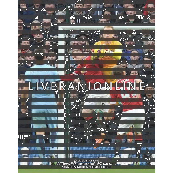 Manchester City\'s Joe Hart and Manchester United\'s Wayne Rooney collide in the goal mouth Photographer Dave Howarth/CameraSport Football - Barclays Premiership - Manchester City v Manchester United - Sunday 2nd November 2014 - Etihad Stdium - Manchester © CameraSport - 43 Linden Ave. Countesthorpe. Leicester. England. LE8 5PG - Tel: +44 (0) 116 277 4147 - admin@camerasport.com - www.camerasport.com AG ALDO LIVERANI SAS ONLY ITALY