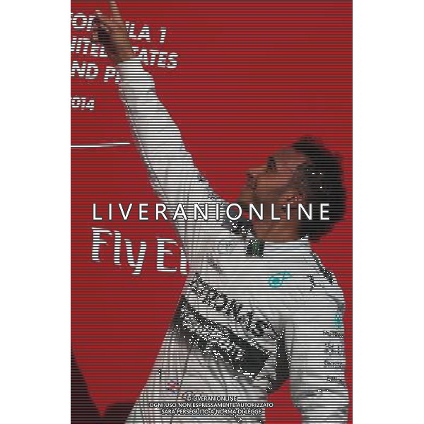 Race winner Lewis Hamilton (GBR) Mercedes AMG F1 celebrates on the podium. 02.11.2014. Formula 1 World Championship, Rd 17, United States Grand Prix, Austin, Texas, USA, Race Day. AG ALDO LIVERANI SAS ONLY ITALY