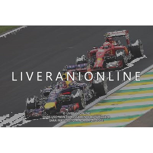 Sebastian Vettel (GER) Red Bull Racing RB10 leads Kimi Raikkonen (FIN) Ferrari F14-T. 08.11.2014. Formula 1 World Championship, Rd 18, Brazilian Grand Prix, Sao Paulo, Brazil, Qualifying Day. - www.xpbimages.com, EMail: requests@xpbimages.com - copy of publication required for printed pictures. Every used picture is fee-liable. © Copyright: Moy / XPB Images /AGENZIA ALDO LIVERANI SAS - ITALY ONLY - EDITORIAL USE ONLY - Grand Prix Gp F1 Brasile prove ufficiali