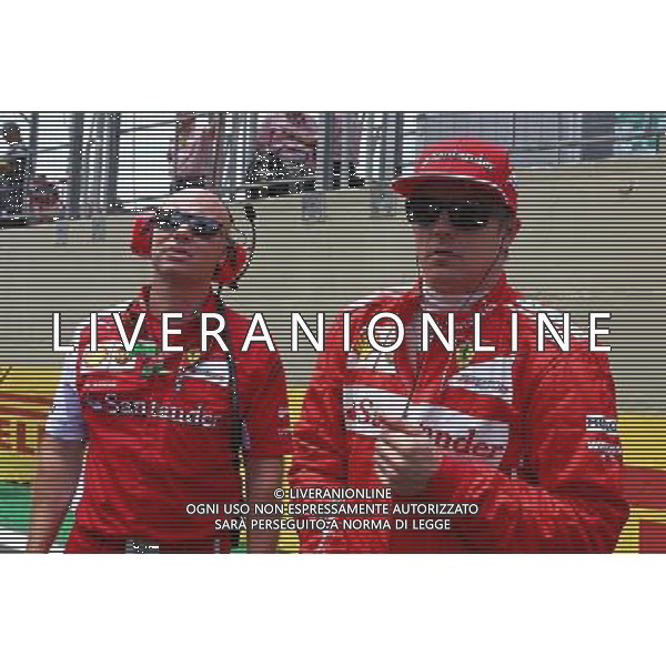 Kimi Raikkonen (FIN) Ferrari with Mark Arnall (GBR) Personal Trainer on the grid. 09.11.2014. Formula 1 World Championship, Rd 18, Brazilian Grand Prix, Sao Paulo, Brazil, Race Day. - www.xpbimages.com, EMail: requests@xpbimages.com - copy of publication required for printed pictures. Every used picture is fee-liable. © Copyright: Batchelor / XPB Images /AGENZIA ALDO LIVERANI SAS - ITALY ONLY - EDITORIAL USE ONLY - Grand Prix Gp F1 Brasile gara