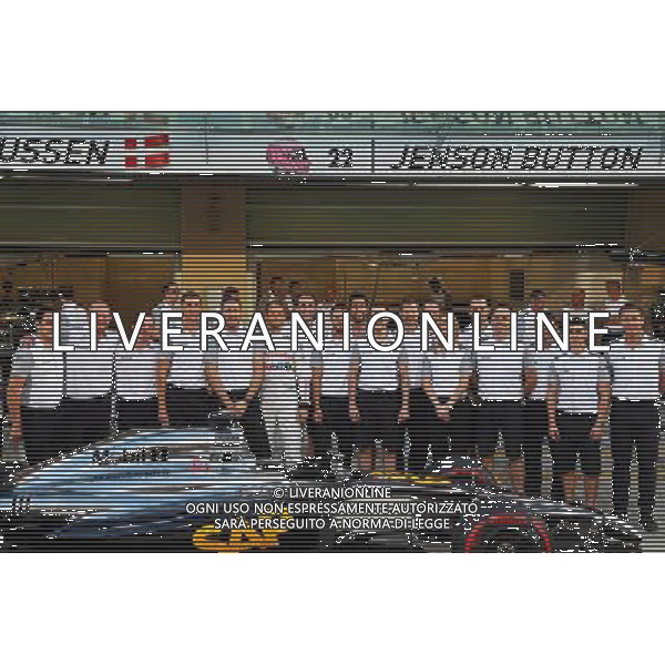 Jenson Button (GBR) McLaren at a team photograph. 20.11.2014. Formula 1 World Championship, Rd 19, Abu Dhabi Grand Prix, Yas Marina Circuit, Abu Dhabi, Preparation Day. AG ALDO LIVERANI SAS ONLY ITALY