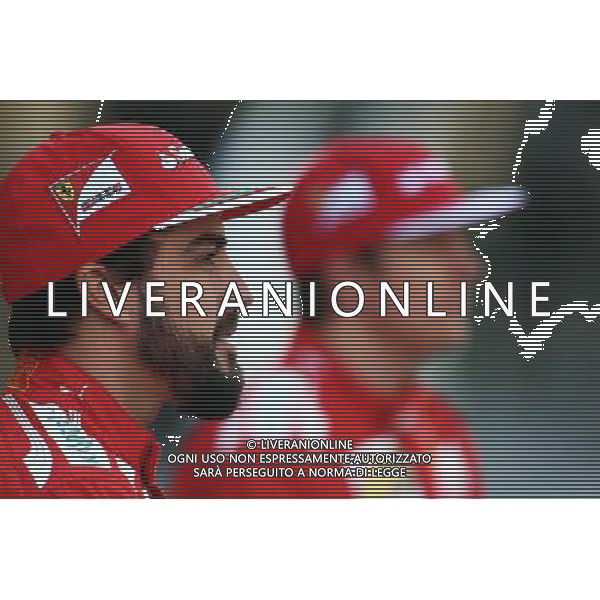 (L to R): Fernando Alonso (ESP) Ferrari and team mate Kimi Raikkonen (FIN) Ferrari at a team photograph. 21.11.2014. Formula 1 World Championship, Rd 19, Abu Dhabi Grand Prix, Yas Marina Circuit, Abu Dhabi, Practice Day. AG ALDO LIVERANI SAS ONLY ITALY