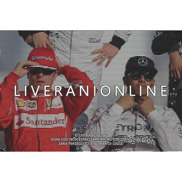 Kimi Raikkonen (FIN), Scuderia Ferrari and Lewis Hamilton (GBR), Mercedes AMG F1 Team 23.11.2014. Formula 1 World Championship, Rd 19, Abu Dhabi Grand Prix, Yas Marina Circuit, Abu Dhabi, Race Day. AG ALDO LIVERANI SAS ONLY ITALY