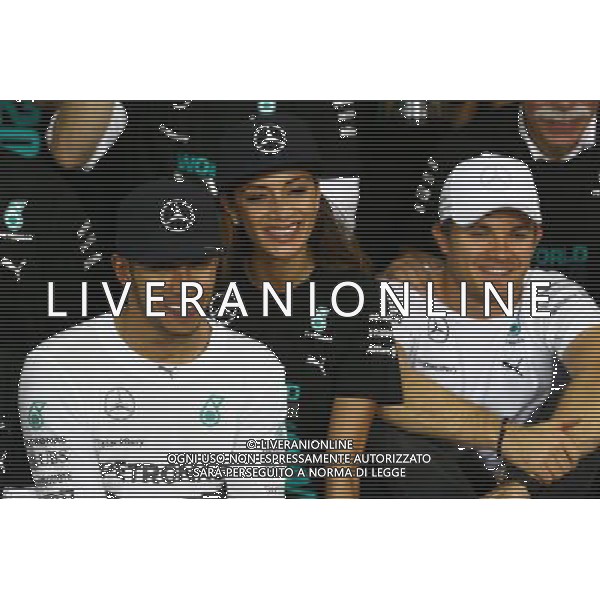 1st place and World Champion Lewis Hamilton (GBR) Mercedes AMG F1 W05 with Nicole Scherzinger (USA) Singer, girlfriend of Lewis Hamilton and Nico Rosberg (GER) Mercedes AMG F1 W05. 23.11.2014. Formula 1 World Championship, Rd 19, Abu Dhabi Grand Prix, Yas Marina Circuit, Abu Dhabi, Race Day. AG ALDO LIVERANI SAS ONLY ITALY