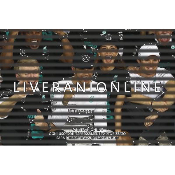 1st place and World Champion Lewis Hamilton (GBR) Mercedes AMG F1 W05 with Nicole Scherzinger (USA) Singer, girlfriend of Lewis Hamilton and Nico Rosberg (GER) Mercedes AMG F1 W05. 23.11.2014. Formula 1 World Championship, Rd 19, Abu Dhabi Grand Prix, Yas Marina Circuit, Abu Dhabi, Race Day. AG ALDO LIVERANI SAS ONLY ITALY
