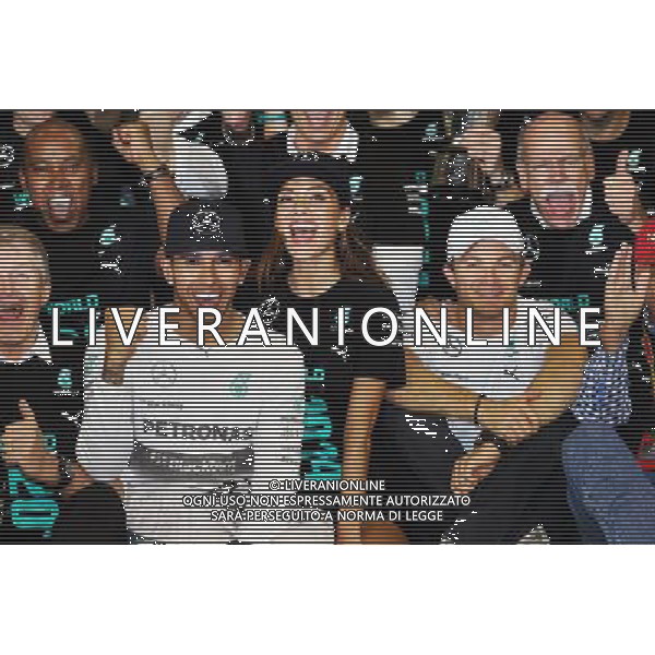 Race winner and World Champion Lewis Hamilton (GBR) Mercedes AMG F1 celebrates with girlfriend Nicole Scherzinger (USA) Singer; team mate Nico Rosberg (GER) Mercedes AMG F1 and the team. 23.11.2014. Formula 1 World Championship, Rd 19, Abu Dhabi Grand Prix, Yas Marina Circuit, Abu Dhabi, Race Day. AG ALDO LIVERANI SAS ONLY ITALY