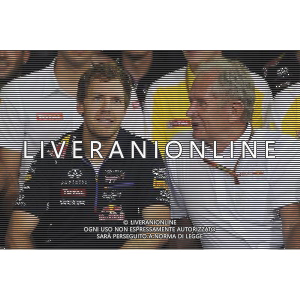 Dr Helmut Marko (AUT) Red Bull Motorsport Consultant (Right) and Red Bull Racing give thanks to the departing Sebastian Vettel (GER) Red Bull Racing. 23.11.2014. Formula 1 World Championship, Rd 19, Abu Dhabi Grand Prix, Yas Marina Circuit, Abu Dhabi, Race Day. AG ALDO LIVERANI SAS ONLY ITALY