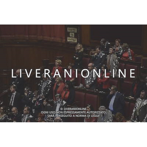 Dichiarazioni di voto del Jobs Act alla camera dall\'aula di Montecitorio Roma 25 novembre 2014 nella foto le deputate indossano indumenti di colore rosso per commemorare la giornata contro la violenza sulle donne ©Corradetti/Agenzia Aldo Liverani sas
