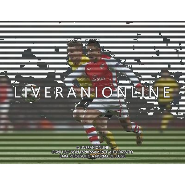 Arsenal\'s Alexis Sanchez under pressure from Borussia Dortmund\'s Lukasz Piszczek Photographer Kieran Galvin/CameraSport Football - UEFA Champions League First Round Group D - Arsenal v Borussia Dortmund - Wednesday 26th November 2014 - Emirates Stadium - London © CameraSport - 43 Linden Ave. Countesthorpe. Leicester. England. LE8 5PG - Tel: +44 (0) 116 277 4147 - admin@camerasport.com - www.camerasport.com AG ALDO LIVERANI SAS ONLY ITALY