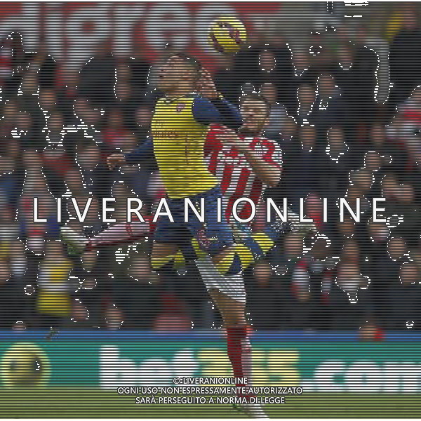 Arsenal\'s Alex Oxlade-Chamberlain jumps with Stoke City\'s Erik Pieters Photographer Mick Walker/CameraSport Football - Barclays Premiership - Stoke City v Arsenal - Saturday 6th December 2014 - Britannia stadium - Stoke © CameraSport - 43 Linden Ave. Countesthorpe. Leicester. England. LE8 5PG - Tel: +44 (0) 116 277 4147 - admin@camerasport.com - www.camerasport.com AG ALDO LIVERANI SAS ONLY ITALY