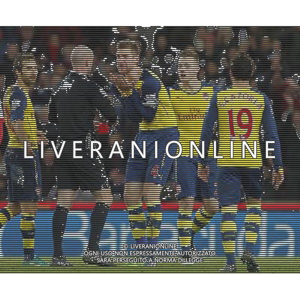 Ref Anthony Taylor sends off Arsenal\'s Calum Chambers as Per Mertesacker pleads for him not to Photographer Mick Walker/CameraSport Football - Barclays Premiership - Stoke City v Arsenal - Saturday 6th December 2014 - Britannia stadium - Stoke © CameraSport - 43 Linden Ave. Countesthorpe. Leicester. England. LE8 5PG - Tel: +44 (0) 116 277 4147 - admin@camerasport.com - www.camerasport.com AG ALDO LIVERANI SAS ONLY ITALY
