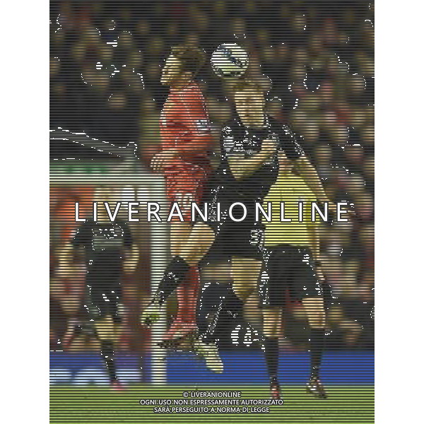Liverpool\'s Adam Lallana and Burnley\'s Scott Arfield jump for the ball Photographer Dave Howarth/CameraSport Football - Barclays Premiership - Liverpool v Burnley - Wednesday 4th March 2015 - Anfield - Liverpool © CameraSport - 43 Linden Ave. Countesthorpe. Leicester. England. LE8 5PG - Tel: +44 (0) 116 277 4147 - admin@camerasport.com - www.camerasport.com /Agenzia Aldo Liverani sas - ITALY ONLY - EDITORIAL USE ONLY