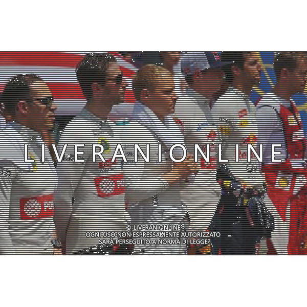 (L to R): Pastor Maldonado (VEN) Lotus F1 Team and Romain Grosjean (FRA) Lotus F1 Team as the grid observes the national anthem. 29.03.2015. Formula 1 World Championship, Rd 2, Malaysian Grand Prix, Sepang, Malaysia, Sunday. /AGENZIA ALDO LIVERANI SAS - ITALY ONLY - EDITORIAL USE ONLY - GP F1 MALESIA GARA 29 MARZO 2015