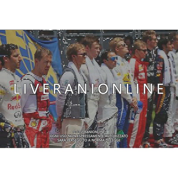 Sebastian Vettel (GER) Ferrari as the grid observes the national anthem. 29.03.2015. Formula 1 World Championship, Rd 2, Malaysian Grand Prix, Sepang, Malaysia, Sunday. /AGENZIA ALDO LIVERANI SAS - ITALY ONLY - EDITORIAL USE ONLY - GP F1 MALESIA GARA 29 MARZO 2015