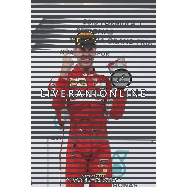 Race winner Sebastian Vettel (GER) Ferrari celebrates on the podium. 29.03.2015. Formula 1 World Championship, Rd 2, Malaysian Grand Prix, Sepang, Malaysia, Sunday. - www.xpbimages.com, EMail: requests@xpbimages.com - copy of publication required for printed pictures. Every used picture is fee-liable. Â© Copyright: Photo4 / XPB Images/Agenzia Aldo Liverani s.a.s.