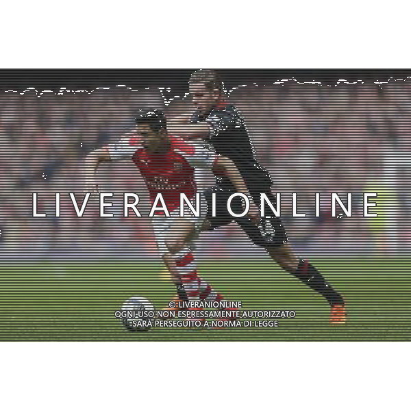 Arsenal\'s Alexis Sanchez battles with Liverpool\'s Jordan Henderson Photographer Craig Mercer/CameraSport Football - Barclays Premiership - Arsenal v Liverpool - Saturday 4th April 2015 - The Emirates Stadium - London © CameraSport - 43 Linden Ave. Countesthorpe. Leicester. England. LE8 5PG - Tel: +44 (0) 116 277 4147 - admin@camerasport.com - www.camerasport.com AG ALDO LIVERANI SAS ONLY ITALY