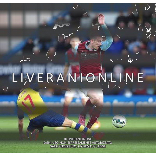 Burnley\'s David Jones is tackled by Arsenal\'s Alexis Sanchez Photographer Chris Vaughan/CameraSport Football - Barclays Premiership - Burnley v Arsenal - Saturday 11th April 2015 - Turf Moor - Burnley Â¬Â© CameraSport - 43 Linden Ave. Countesthorpe. Leicester. England. LE8 5PG - Tel: +44 (0) 116 277 4147 - admin@camerasport.com - www.camerasport.com AG ALDO LIVERANI SAS ONLY ITALY