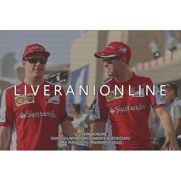 (L to R): Kimi Raikkonen (FIN) Ferrari with team mate Sebastian Vettel (GER) Ferrari on the drivers parade. 19.04.2015. Formula 1 World Championship, Rd 4, Bahrain Grand Prix, Sakhir, Bahrain, Race Day. AG ALDO LIVERANI SAS ONLY ITALY
