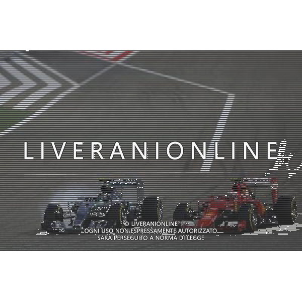 (L to R): Nico Rosberg (GER) Mercedes AMG F1 W06 locks up under braking as he battle for position with Kimi Raikkonen (FIN) Ferrari SF15-T. 19.04.2015. Formula 1 World Championship, Rd 4, Bahrain Grand Prix, Sakhir, Bahrain, Race Day. AG ALDO LIVERANI SAS ONLY ITALY