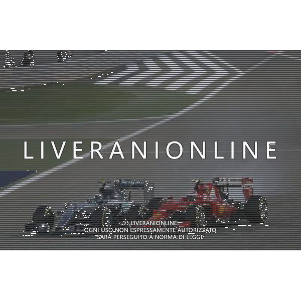 (L to R): Nico Rosberg (GER) Mercedes AMG F1 W06 locks up under braking as he battle for position with Kimi Raikkonen (FIN) Ferrari SF15-T. 19.04.2015. Formula 1 World Championship, Rd 4, Bahrain Grand Prix, Sakhir, Bahrain, Race Day. AG ALDO LIVERANI SAS ONLY ITALY