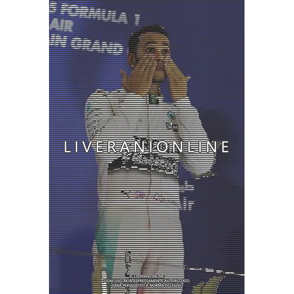Race winner Lewis Hamilton (GBR) Mercedes AMG F1 celebrates on the podium. 19.04.2015. Formula 1 World Championship, Rd 4, Bahrain Grand Prix, Sakhir, Bahrain, Race Day. /Agenzia Aldo Liverani sas - ITALY ONLY - EDITORIAL USE ONLY - GARA