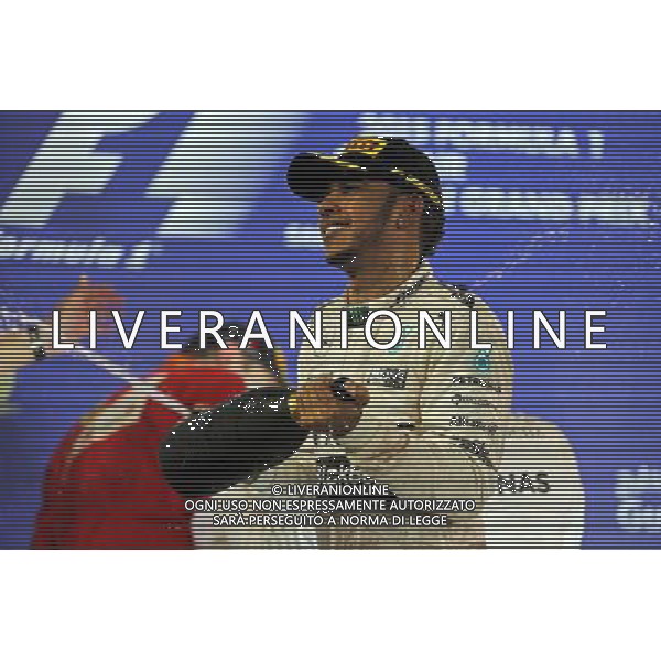 Race winner Lewis Hamilton (GBR) Mercedes AMG F1 celebrates on the podium. 19.04.2015. Formula 1 World Championship, Rd 4, Bahrain Grand Prix, Sakhir, Bahrain, Race Day. /Agenzia Aldo Liverani sas - ITALY ONLY - EDITORIAL USE ONLY - GARA