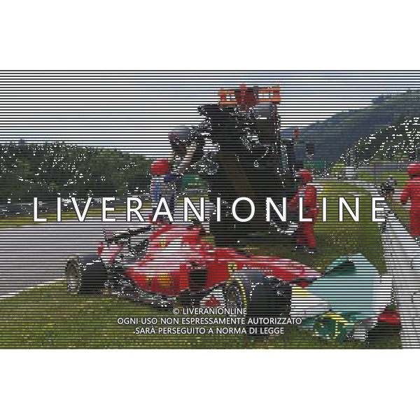 Marshals remove the start crash involving Fernando Alonso (ESP) McLaren MP4-30 and Kimi Raikkonen (FIN) Ferrari SF15-T. 21.06.2015. Formula 1 World Championship, Rd 8, Austrian Grand Prix, Spielberg, Austria, Race Day. /AGENZIA ALDO LIVERANI Sas - ITALY ONLY - EDITORIAL USE ONLY - GARA