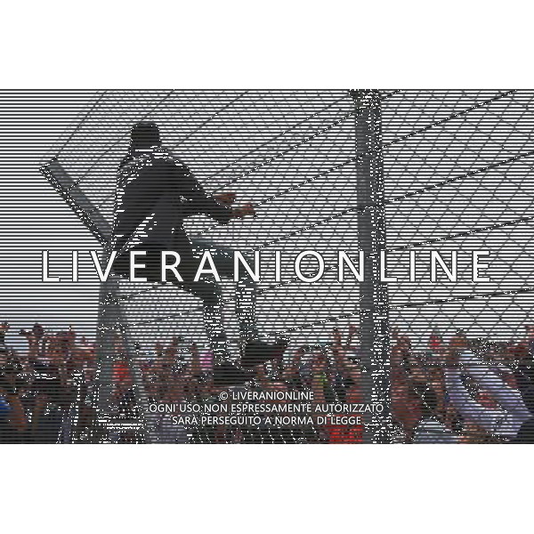 Lewis Hamilton (GBR) Mercedes AMG F1 climbs hte fence to greet the fans. 05.07.2015. Formula 1 World Championship, Rd 9, British Grand Prix, Silverstone, England, Race Day. AG ALDO LIVERANI SAS ONLY ITALY