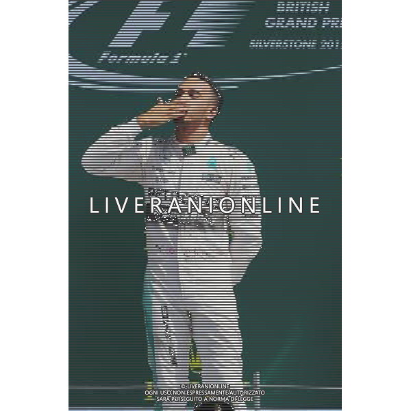 Race winner Lewis Hamilton (GBR) Mercedes AMG F1 celebrates on the podium. 05.07.2015. Formula 1 World Championship, Rd 9, British Grand Prix, Silverstone, England, Race Day. AG ALDO LIVERANI SAS ONLY ITALY