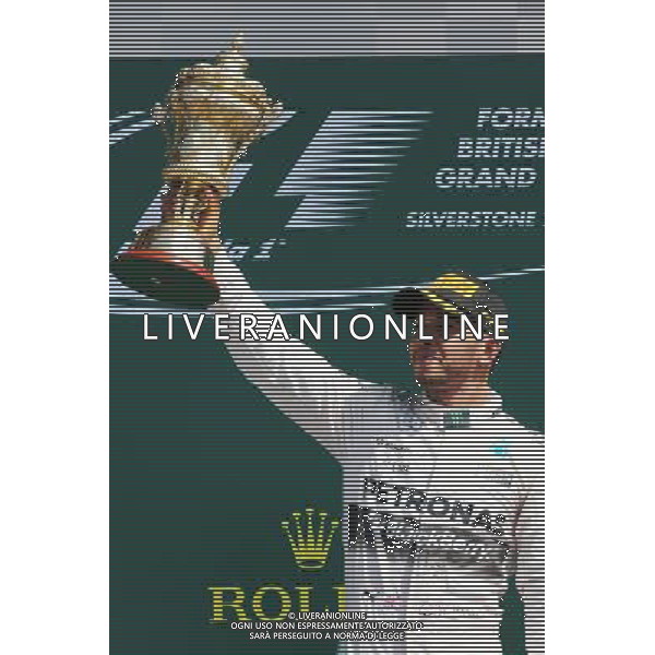 Race winner Lewis Hamilton (GBR) Mercedes AMG F1 celebrates on the podium. 05.07.2015. Formula 1 World Championship, Rd 9, British Grand Prix, Silverstone, England, Race Day. AG ALDO LIVERANI SAS ONLY ITALY