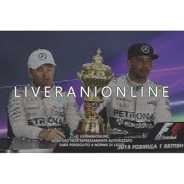 (L to R): Second placed Nico Rosberg (GER) Mercedes AMG F1 with the trophy of race winner Lewis Hamilton (GBR) Mercedes AMG F1 in the FIA Press Conference. 05.07.2015. Formula 1 World Championship, Rd 9, British Grand Prix, Silverstone, England, Race Day. AG ALDO LIVERANI SAS ONLY ITALY