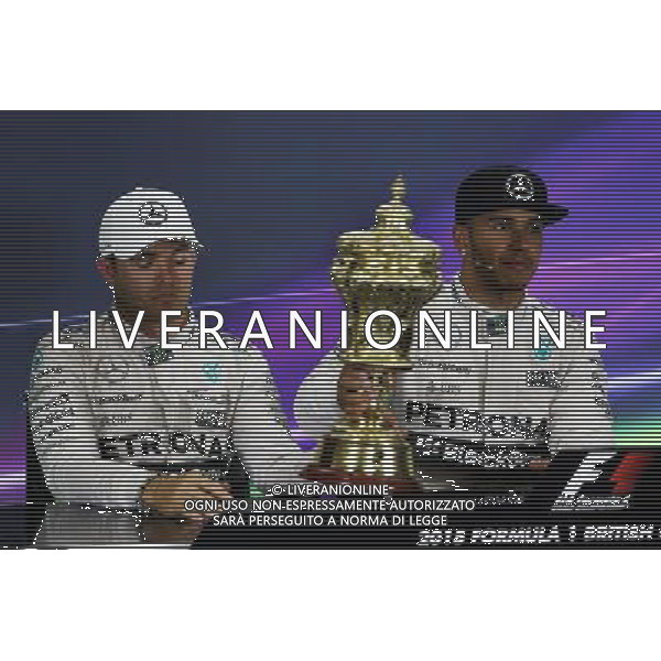 (L to R): Second placed Nico Rosberg (GER) Mercedes AMG F1 with the trophy of race winner Lewis Hamilton (GBR) Mercedes AMG F1 in the FIA Press Conference. 05.07.2015. Formula 1 World Championship, Rd 9, British Grand Prix, Silverstone, England, Race Day. AG ALDO LIVERANI SAS ONLY ITALY