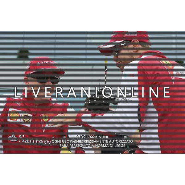 (L to R): Kimi Raikkonen (FIN) Ferrari with Sebastian Vettel (GER) Ferrari on the drivers parade. 05.07.2015. Formula 1 World Championship, Rd 9, British Grand Prix, Silverstone, England, Race Day. AG ALDO LIVERANI SAS ONLY ITALY