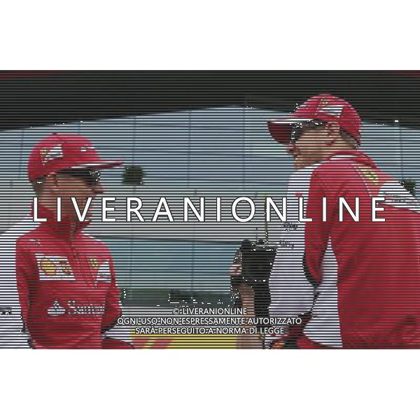 (L to R): Kimi Raikkonen (FIN) Ferrari with Sebastian Vettel (GER) Ferrari on the drivers parade. 05.07.2015. Formula 1 World Championship, Rd 9, British Grand Prix, Silverstone, England, Race Day. AG ALDO LIVERANI SAS ONLY ITALY
