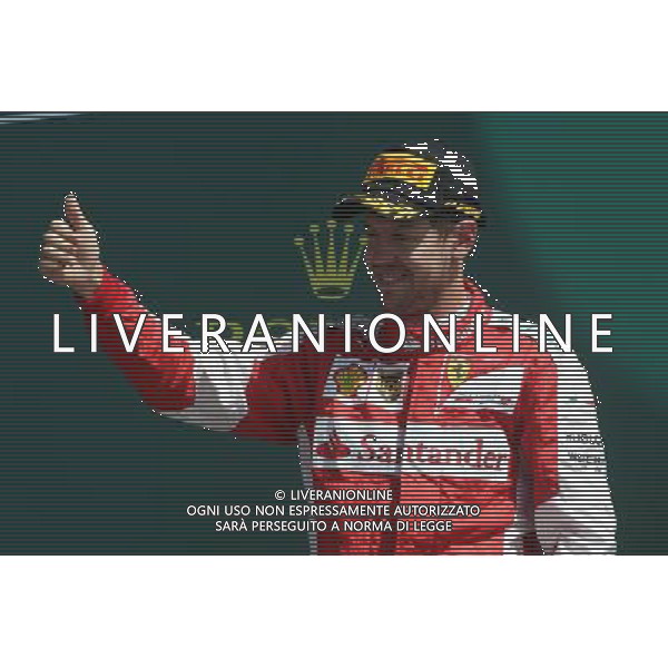Sebastian Vettel (GER) Ferrari celebrates his third position on the podium. 05.07.2015. Formula 1 World Championship, Rd 9, British Grand Prix, Silverstone, England, Race Day. AG ALDO LIVERANI SAS ONLY ITALY