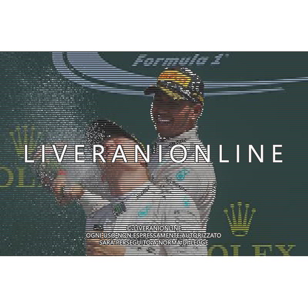 Race winner Lewis Hamilton (GBR) Mercedes AMG F1 celebrates on the podium with team mate Nico Rosberg (GER) Mercedes AMG F1. 05.07.2015. Formula 1 World Championship, Rd 9, British Grand Prix, Silverstone, England, Race Day. AG ALDO LIVERANI SAS ONLY ITALY