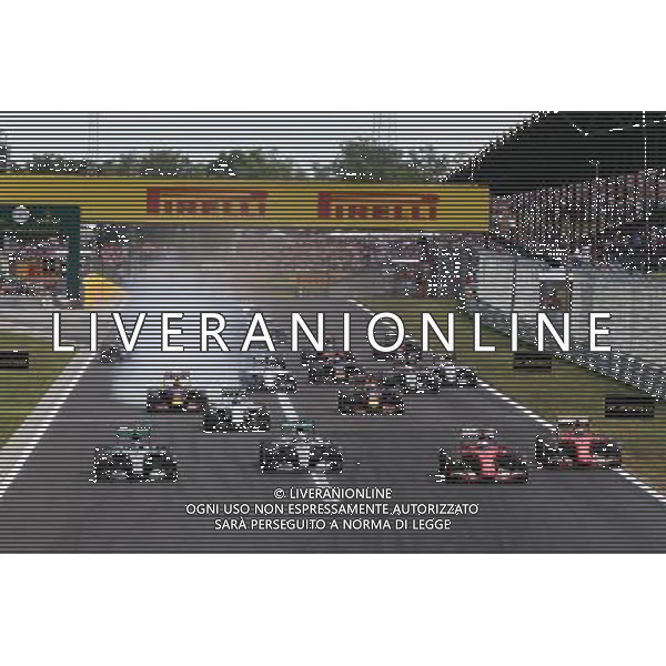 (L to R): Nico Rosberg (GER) Mercedes AMG F1 W06; Lewis Hamilton (GBR) Mercedes AMG F1 W06; Sebastian Vettel (GER) Ferrari SF15-T; and Kimi Raikkonen (FIN) Ferrari SF15-T at the start of the race. 26.07.2015. Formula 1 World Championship, Rd 10, Hungarian Grand Prix, Budapest, Hungary, Race Day. /AGENZIA ALDO LIVERANI Sas - ITALY ONLY - EDITORIAL USE ONLY