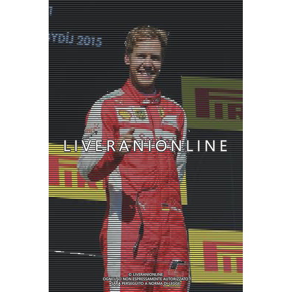 Race winner Sebastian Vettel (GER) Ferrari celebrates on the podium. 26.07.2015. Formula 1 World Championship, Rd 10, Hungarian Grand Prix, Budapest, Hungary, Race Day. AG ALDO LIVERANI SAS ONLY ITALY